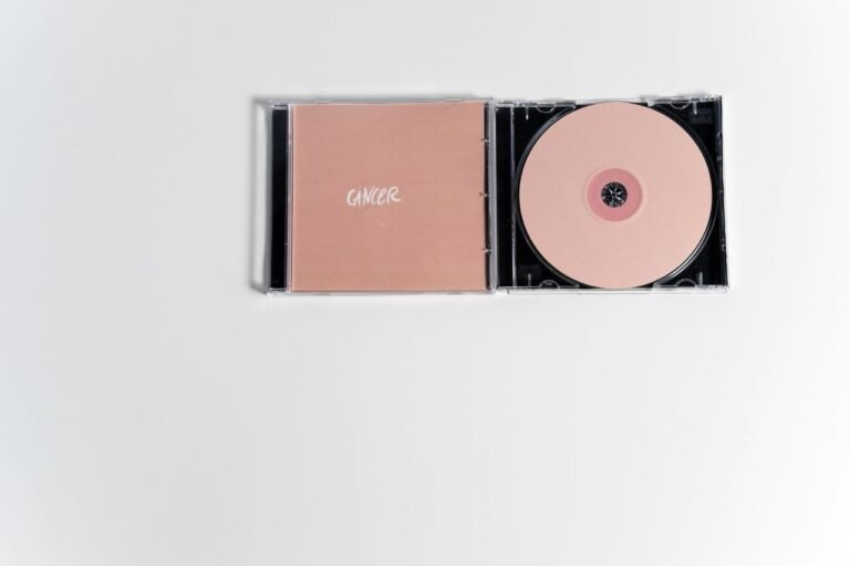 Conceptual CD cover with a focus on cancer theme, featuring a flatlay of a compact disc.